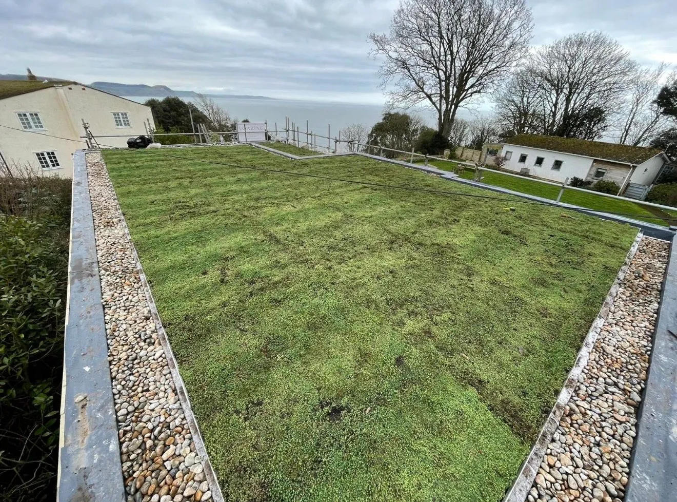 Green roof with pebble border overlooking the sea